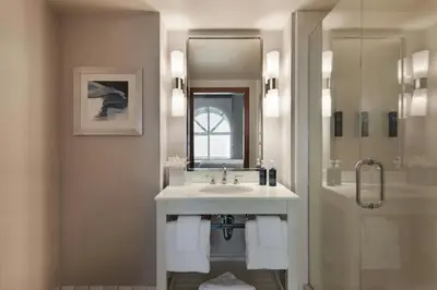 a bathroom with a sink and a mirror and a shower at Four Points by Sheraton, Ontario-Rancho Cucamonga in Rancho Cucamonga