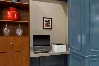 a computer monitor and a printer on a desk at Four Points by Sheraton, Ontario-Rancho Cucamonga in Rancho Cucamonga