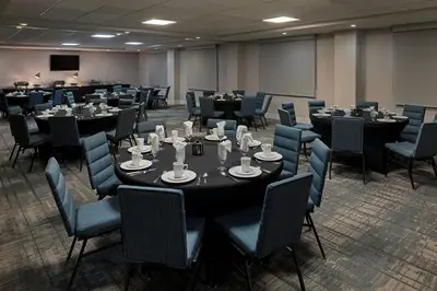 a conference room with tables and chairs with cups on them at Four Points by Sheraton, Ontario-Rancho Cucamonga in Rancho Cucamonga