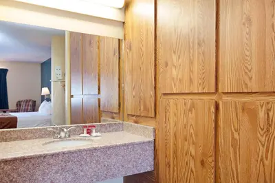 a bathroom with a sink and a mirror at America's Best Value Inn & Suites Bakersfield Central in Bakersfield