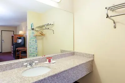 a bathroom with a sink and a mirror at America's Best Value Inn & Suites Bakersfield Central in Bakersfield