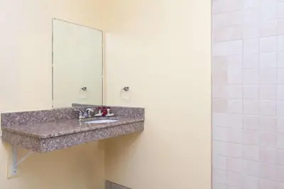 a bathroom with a sink and a mirror at America's Best Value Inn & Suites Bakersfield Central in Bakersfield