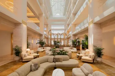 a large lobby with couches and chairs in a building at Regent Santa Monica Beach in Los Angeles