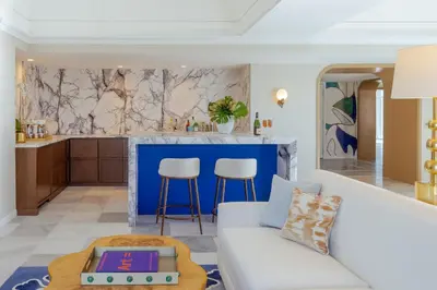 a living room with a couch and a kitchen at Regent Santa Monica Beach in Los Angeles