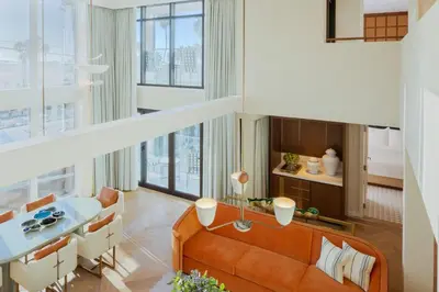 a living room with a couch and a table at Regent Santa Monica Beach in Los Angeles