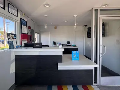 a restaurant with a counter with a blue box on it at Motel 6 Ontario, CA - Airport in Ontario