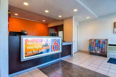 a waiting area at a fast food restaurant with a sign at Motel 6-Rowland Heights, CA - Los Angeles - Pomona in Rowland Heights