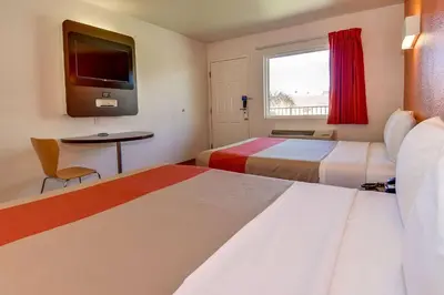 a hotel room with two beds and a tv at Motel 6-Riverside, CA - South in Riverside