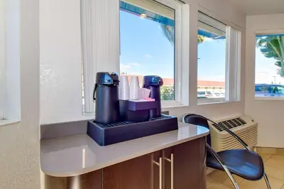 a hair dryer sitting on a counter with two chairs at Motel 6-Riverside, CA - South in Riverside