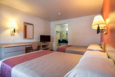 a hotel room with two beds and a desk at Motel 6-San Dimas, CA - Los Angeles in San Dimas