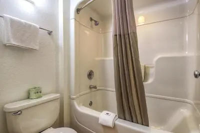 a bathroom with a white toilet and a shower at Motel 6-San Dimas, CA - Los Angeles in San Dimas