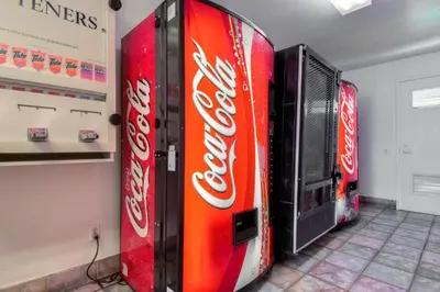 a coke vending machine in a room with soda cans at Motel 6-San Dimas, CA - Los Angeles in San Dimas