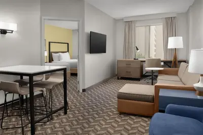 a hotel room with a bed and a table and chairs at Residence Inn by Marriott Anaheim Resort Area/Garden Grove in Anaheim