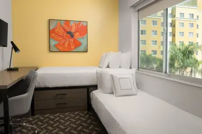 a room with two beds and a desk and a window at Residence Inn by Marriott Anaheim Resort Area/Garden Grove in Anaheim
