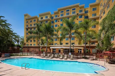 a hotel with a swimming pool in front of a building at Residence Inn by Marriott Anaheim Resort Area/Garden Grove in Anaheim