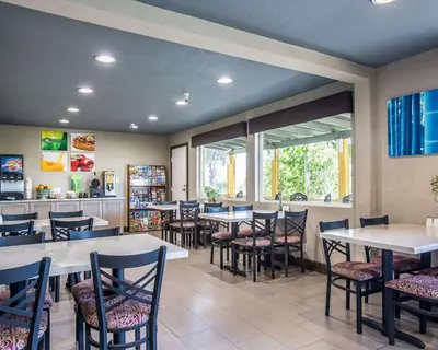 a dining room with tables and chairs in a restaurant at Quality Inn Ontario Airport Convention Center in Ontario