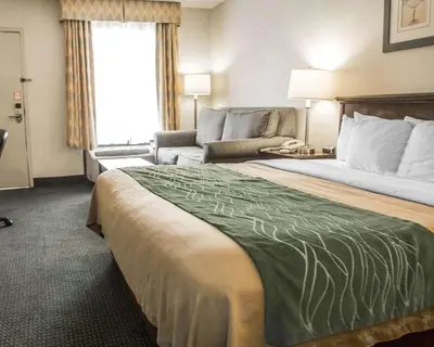 a hotel room with a large bed and a couch at Quality Inn Riverside near UCR and Downtown in Riverside