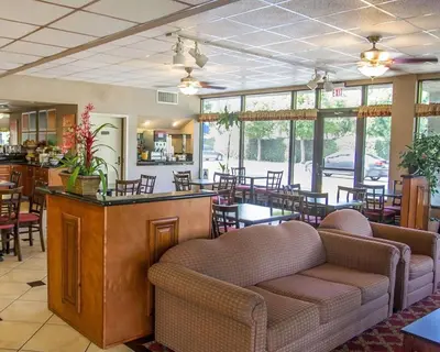 a restaurant with chairs and tables and a bar at Quality Inn Riverside near UCR and Downtown in Riverside