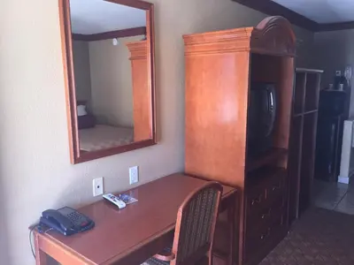 a wooden desk in a room with a mirror at Thunderbird Lodge in Riverside
