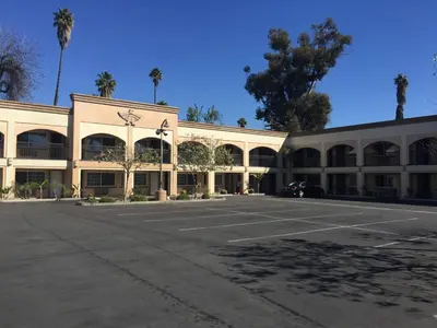 an empty parking lot in front of a building at Thunderbird Lodge in Riverside