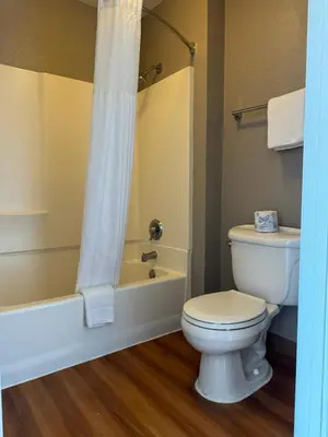 a bathroom with a white toilet and a bath tub at Motel 6-Ventura, CA - South in Ventura