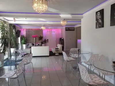a room with tables and chairs and pink lighting at Hollywood VIP Hotel in Los Angeles