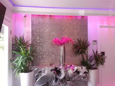 a room with pink flowers in vases on a table at Hollywood VIP Hotel in Los Angeles