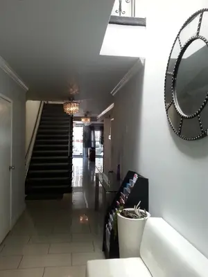 a hallway with stairs and a mirror on the wall at Hollywood VIP Hotel in Los Angeles