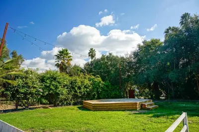 a backyard with a wooden table in the grass at Ojai Rancho Inn in Ojai