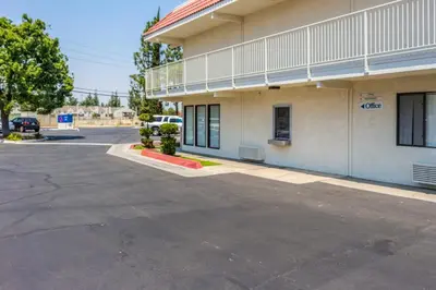 a parking lot in front of a building at Motel 6 Bakersfield, CA - Convention Center in Bakersfield