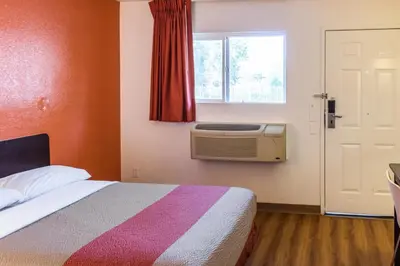 a bedroom with a bed and a window and a radiator at Motel 6 Bakersfield, CA - Convention Center in Bakersfield