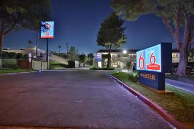 an empty street with a gas station at night at Motel 6-Barstow, CA in Barstow