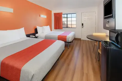 a hotel room with two beds and a television at Motel 6-Thousand Oaks, CA in Thousand Oaks