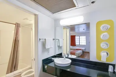 a bathroom with a sink and a large mirror at Motel 6-Thousand Oaks, CA in Thousand Oaks