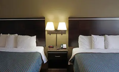 two beds in a hotel room with two lamps at Hawthorne Plaza Inn Near LAX in Hawthorne