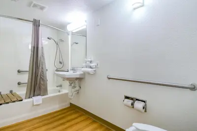 a bathroom with a sink and a toilet and a mirror at Motel 6-Pomona, CA - Los Angeles in Pomona