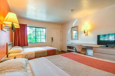 a hotel room with two beds and a flat screen tv at Motel 6-Pomona, CA - Los Angeles in Pomona