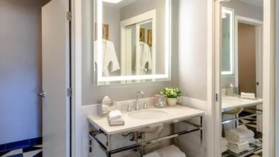 a bathroom with two sinks and a mirror at Chamberlain West Hollywood in Los Angeles