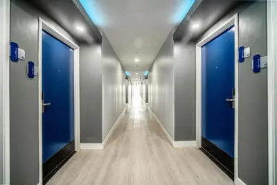 a corridor of a hospital hallway with blue doors at Rodeway Inn & Suites Pasadena in Pasadena
