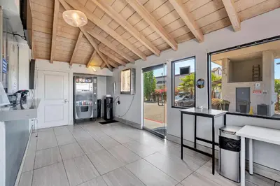 a large kitchen with white appliances and wooden ceilings at Morada Inn in Anaheim