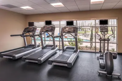 a gym with cardio equipment and a large window at TownePlace Suites by Marriott San Bernardino Loma Linda in Loma Linda