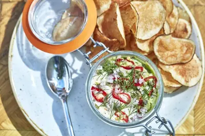a plate of food with a salad and chips at Avalon Hotel Beverly Hills, a Member of Design Hotels in Los Angeles