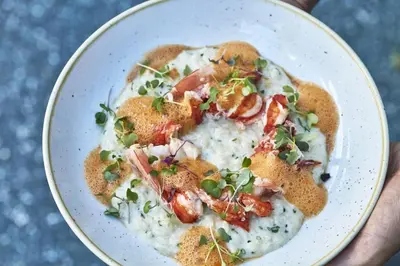 a bowl of mashed potatoes with bacon and green onions at Avalon Hotel Beverly Hills, a Member of Design Hotels in Los Angeles
