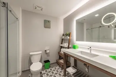 a bathroom with a toilet and a sink and a mirror at Lexen Hotel - North Hollywood Near Universal Studios in North Hollywood
