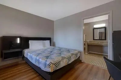 a hotel room with a bed and a bathroom at Motel 6-Buttonwillow, CA Central in Buttonwillow