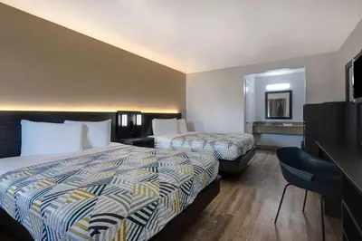 a hotel room with two beds and a mirror at Motel 6-Buttonwillow, CA Central in Buttonwillow