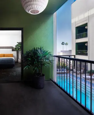 a room with a swimming pool and a green wall at The Aster in Los Angeles