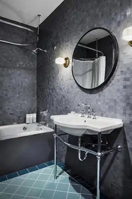 a bathroom with a sink and a tub and a mirror at The Aster in Los Angeles