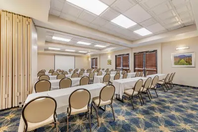 a conference room with white tables and chairs and a whiteboard at Best Western Plus Heritage Inn Ontario Rancho Cucamonga in Rancho Cucamonga