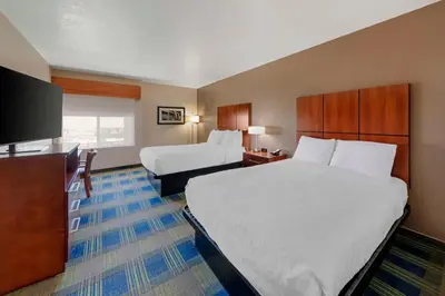 a hotel room with two beds and a flat screen tv at Best Western Plus Heritage Inn Ontario Rancho Cucamonga in Rancho Cucamonga